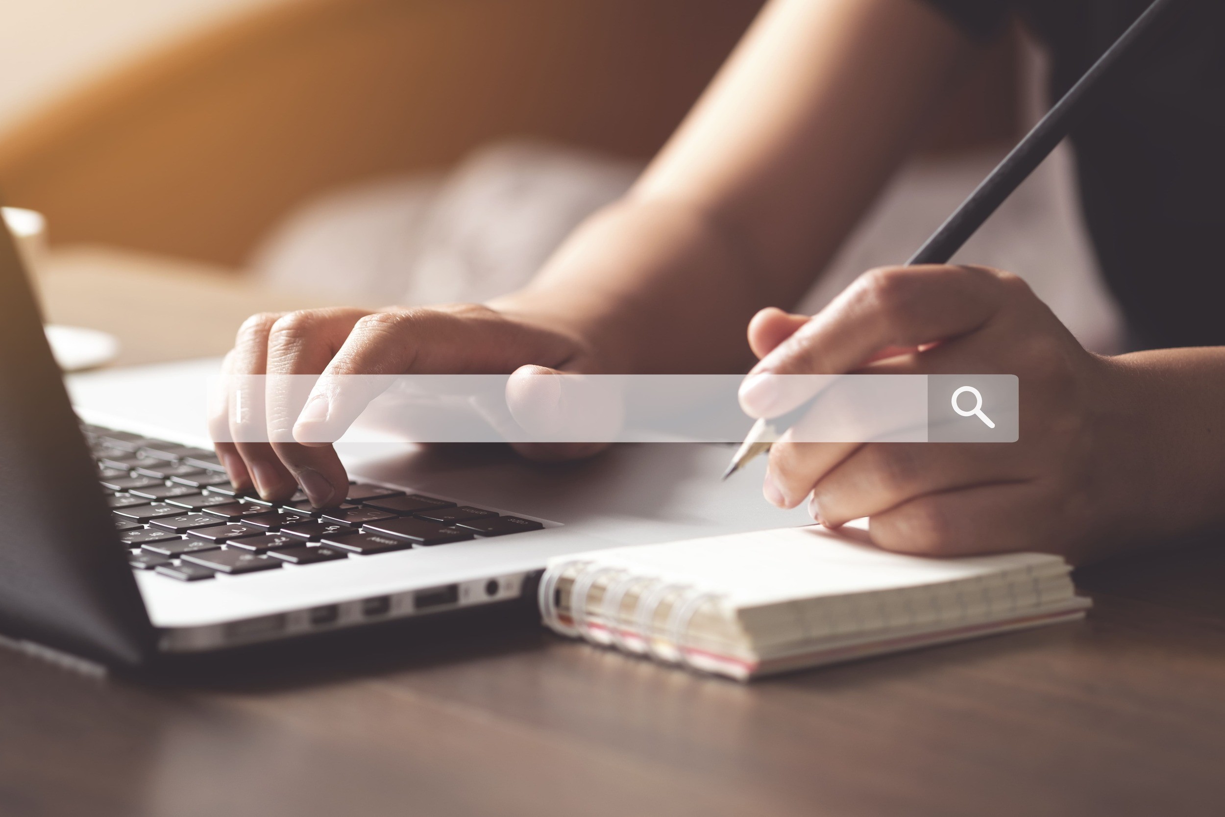 cropped-hands-woman-writing-diary-while-using-laptop-table (1)